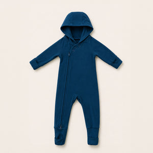 Blue baby onesie with a hood on a beige background
